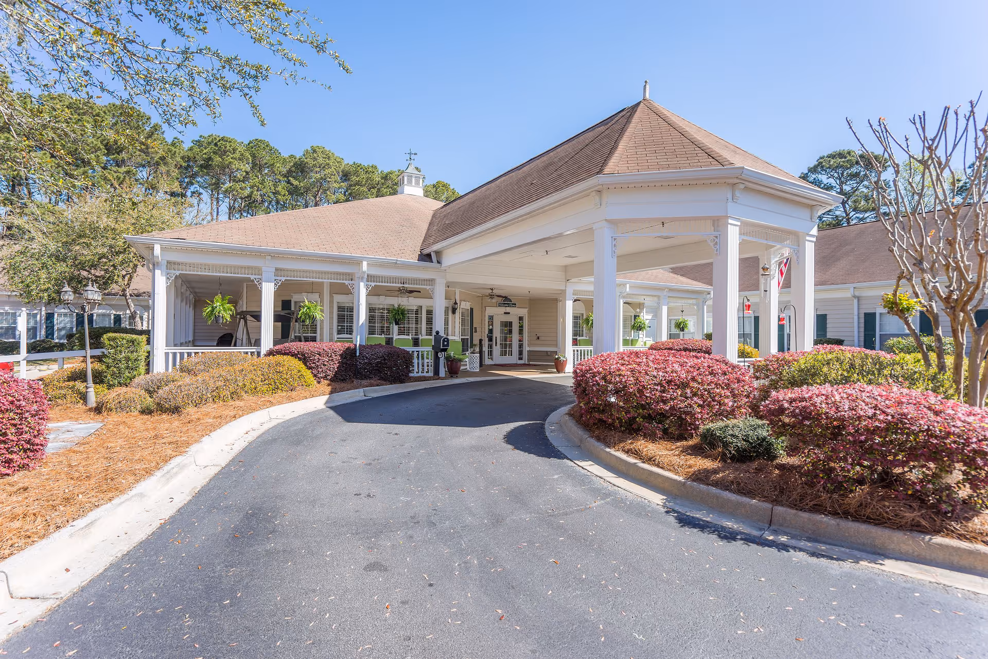 Entrance of the Oaks At Salem Road senior living facility with landscaped gardens.