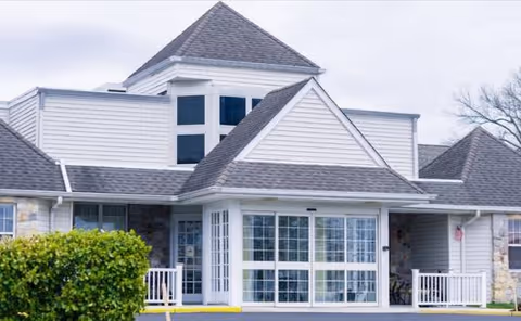 Exterior view of a Silver Healthcare facility with a glass entry and peaked roof.