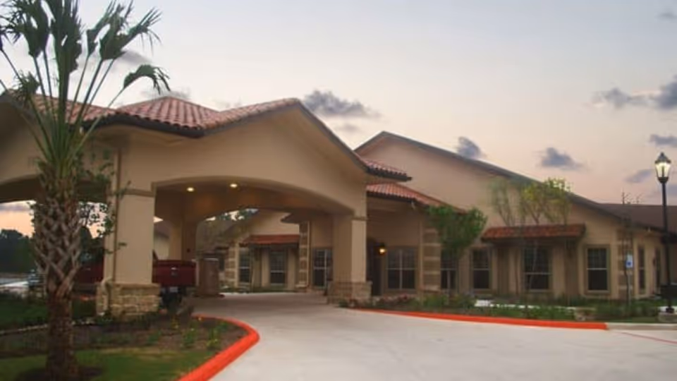 Exterior view of Fox Hollow Post Acute senior living facility with a landscaped entrance.