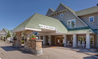 Exterior view of the Assisted Living at St. Andrews Village entrance with stone pillars