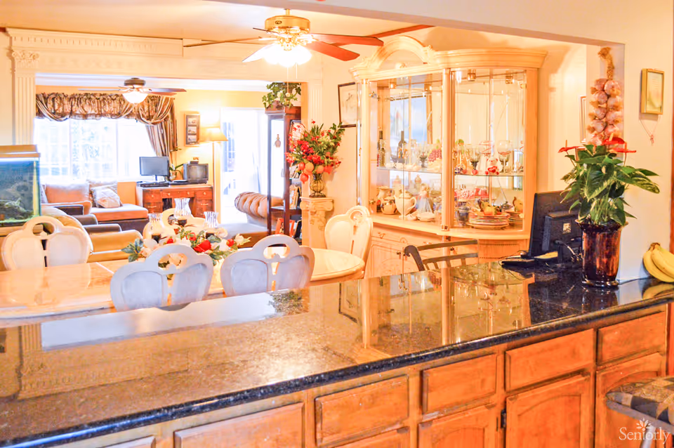 A spacious living area with a kitchen counter, comfortable seating, and decorative elements.
