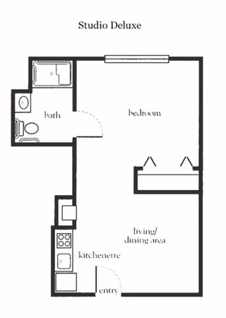 Floor plan labeled Studio Deluxe showing a layout with a bath, bedroom, living/dining area, kitchenette, and entry. The bath includes a toilet and shower. The kitchenette has a stove and sink. The living/dining area is adjacent to the bedroom.