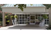 Front view of a McGuffey Healthcare building with a covered entrance and rocking chairs.