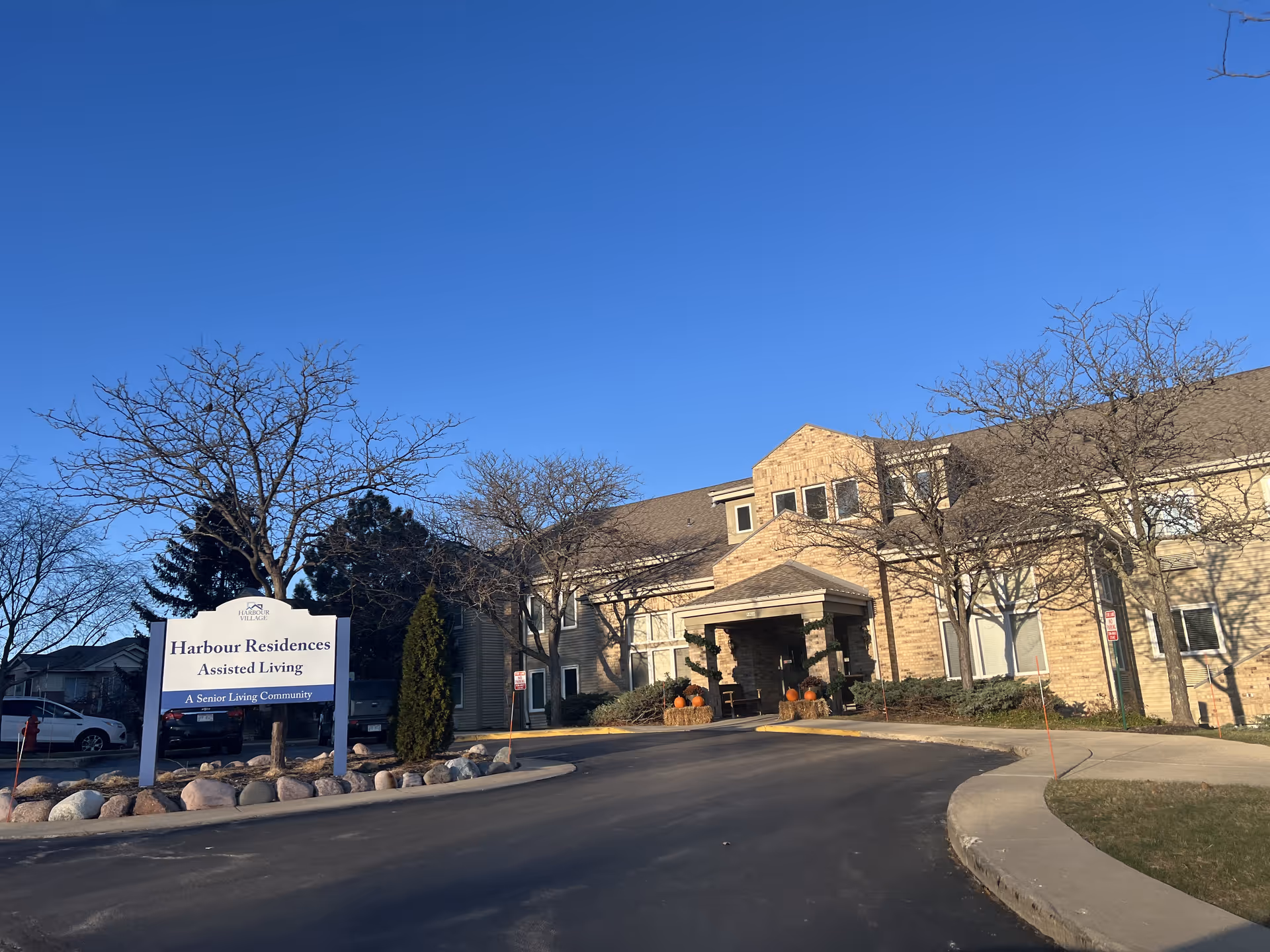 Exterior view of Harbour Residences Assisted Living facility with signage.