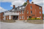 Brick exterior of Morrison Skilled Nursing and Assisted Living with entrance and planters.