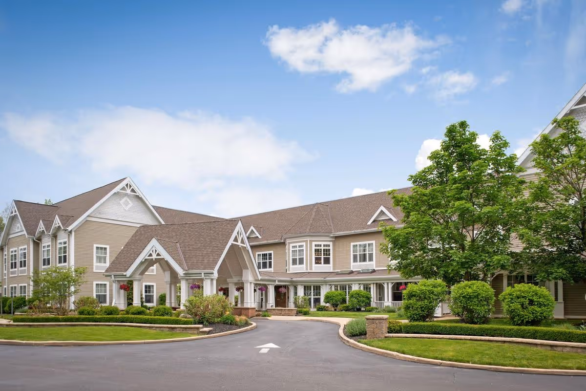 Sunrise of Cuyahoga Falls exterior view of a beige senior living building with landscaping