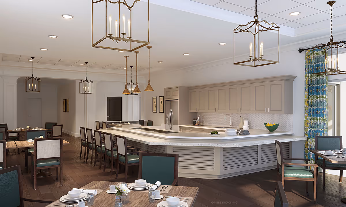 A spacious dining area with multiple wooden tables and chairs, set with white dishes and napkins. The room features a large kitchen island with a white countertop, a built-in stovetop, and a sink. Above the island hang several decorative pendant lights and chandeliers. The kitchen area has light-colored cabinets and a stainless steel refrigerator. The room has dark wooden flooring and large windows with blue and green patterned curtains allowing natural light to enter.