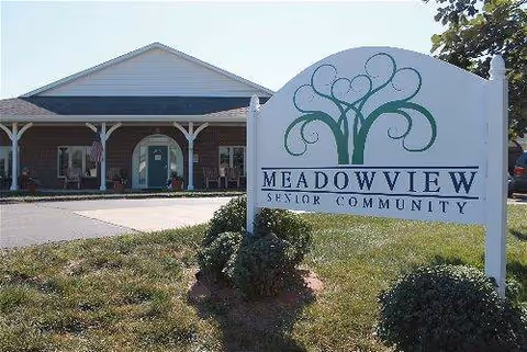 Front view of Meadowview Senior Community building with a decorative sign in foreground.