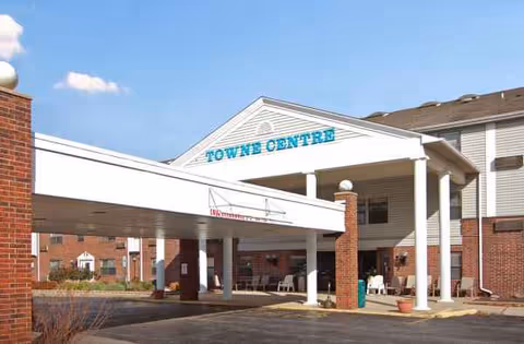 Exterior view of Towne Centre senior living building with entrance canopy and brick facade.