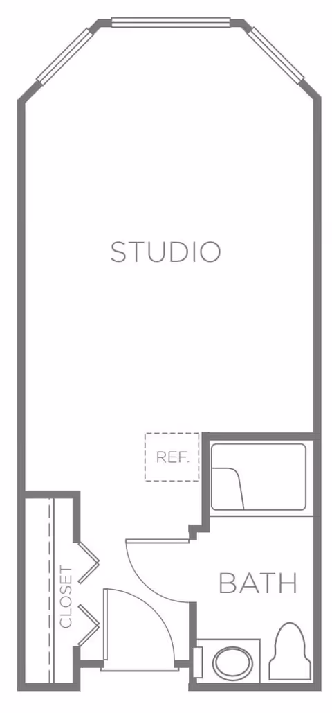 Floor plan of a studio apartment with a closet near the entrance, a bathroom with a bathtub, toilet, and sink, and a main studio living area. The layout includes a designated space for a refrigerator.