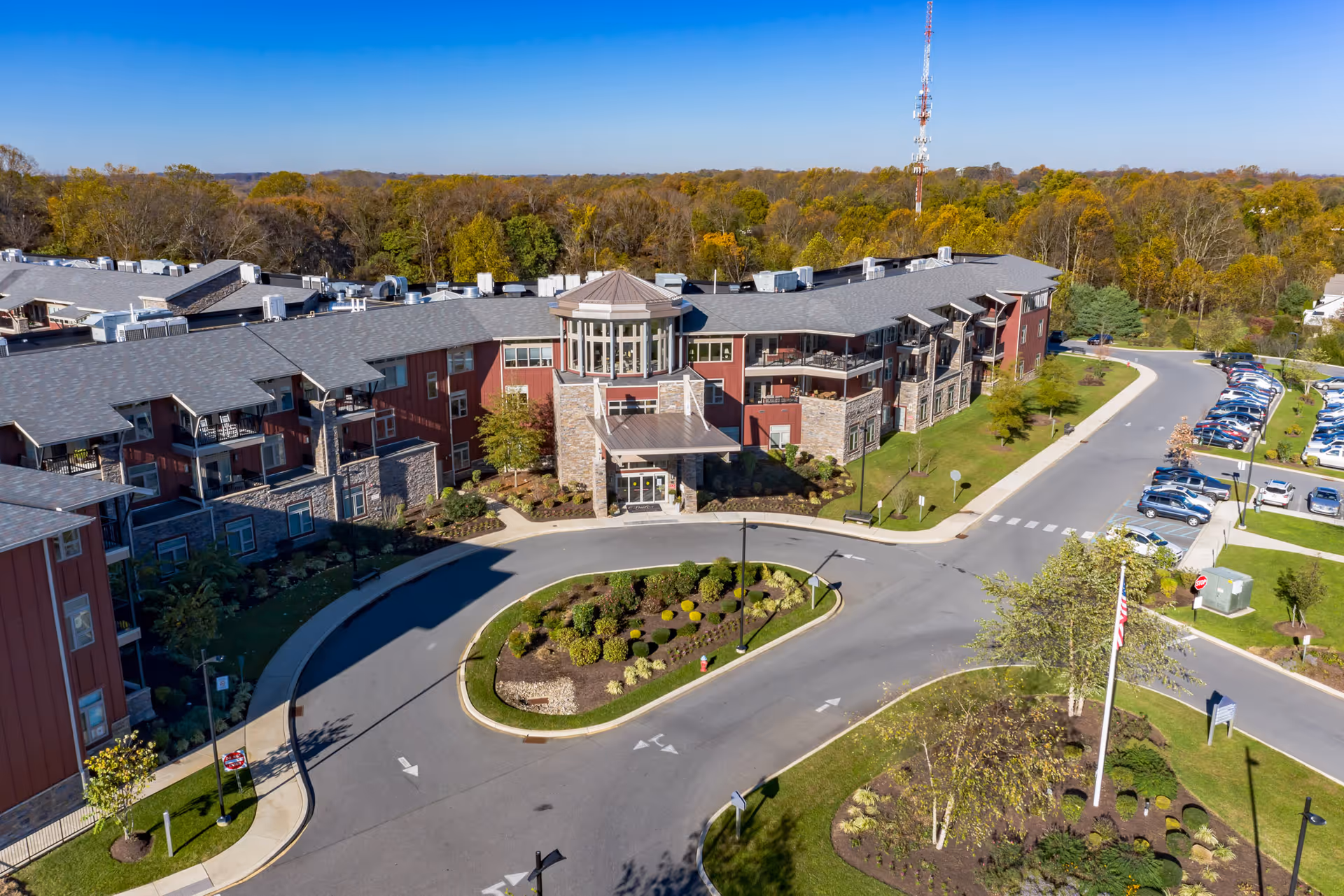 Aerial view of The Summit senior living building with a circular drive, landscaped center island, and adjacent parking.