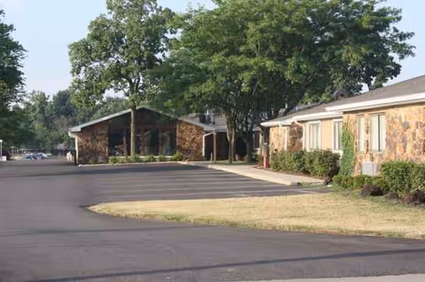Exterior view of Woodview A Waters Community building with a parking lot.