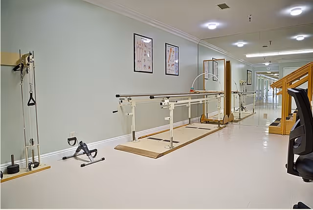 Hallway therapy area with parallel walking bars, exercise equipment, a small set of stairs and mirrors.