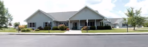 Edgewood Mitchell Memory Care building with a front entrance, walkway, and manicured landscaping.