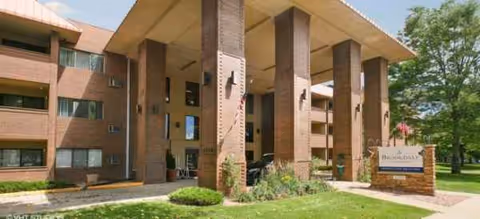 Exterior view of Brookdale North Boulder with brick columns and a welcoming entrance.