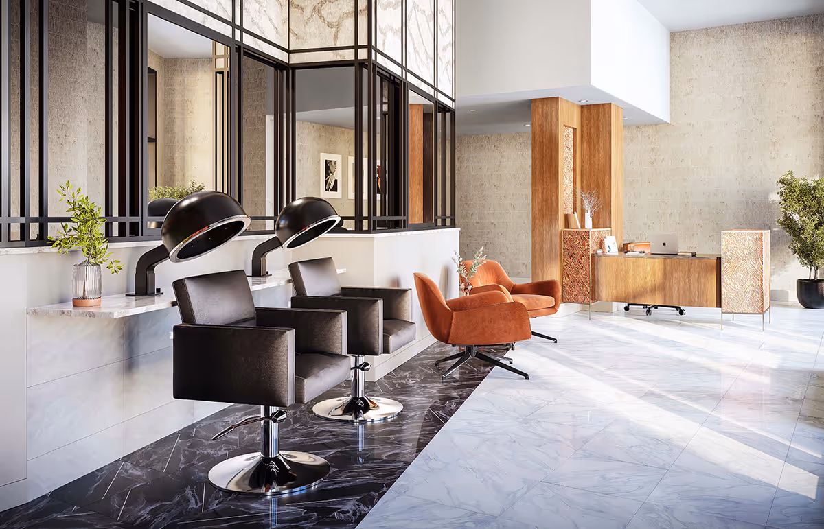 Bright modern interior showing salon styling stations with hooded dryers and black chairs on the left, orange lounge chairs and a wooden reception desk on the right.