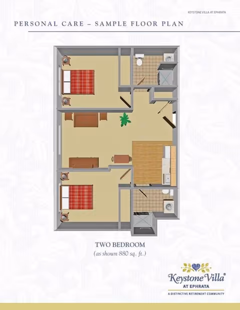Floor plan layout of a two-bedroom personal care unit at Keystone Villa at Ephrata, showing two bedrooms with beds and nightstands, a living area with seating, a kitchen area, and two bathrooms with shower and toilet facilities.