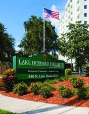 Exterior front view of Lake Howard Heights with signage and landscaping.