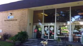 Entrance to A Grace Subacute & Skilled Care with glass doors and people inside.