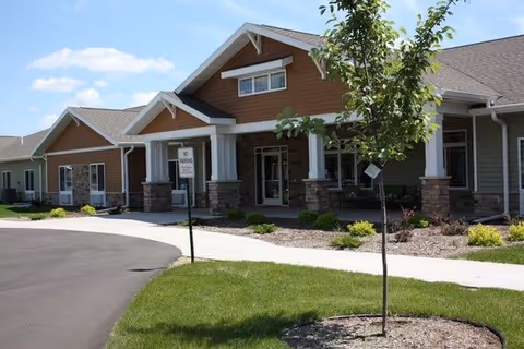 Exterior view of Amery Memory Care building with entrance and landscaped frontage.