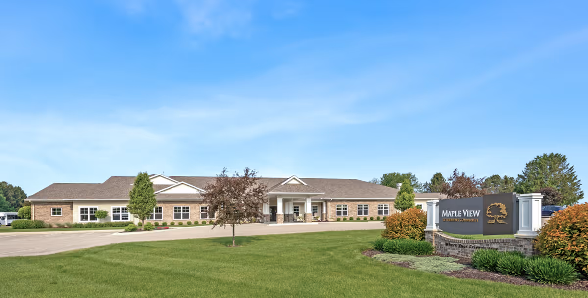 A single-story retirement community building with a Maple View sign and well-kept landscaping.