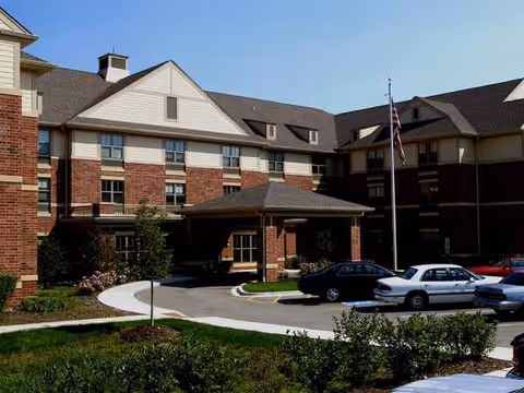 Exterior view of Alexian Village of Elk Grove, showing brick building and entrance.