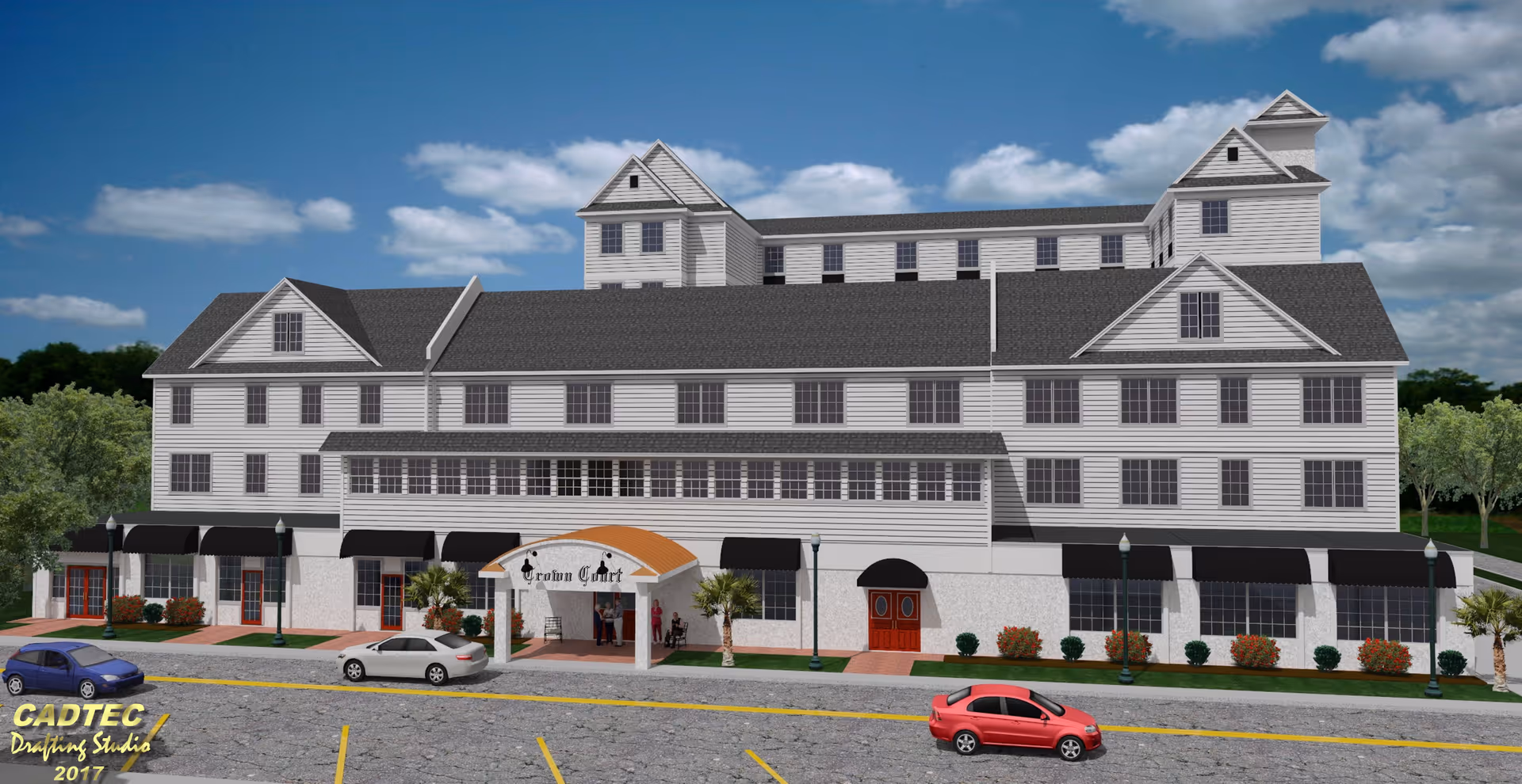 Exterior view of a large multi-story senior living facility named Crown Court with white siding and black awnings over the windows. There are three cars parked in front of the building and a covered entrance with the facility name displayed. The sky is blue with some clouds and there are trees in the background.
