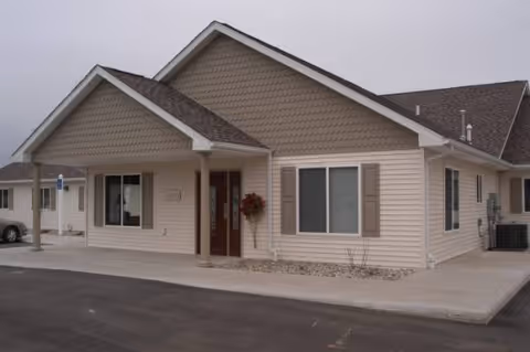 Front exterior of The Horizon Senior Living I, a single-story beige building with a peaked roof.