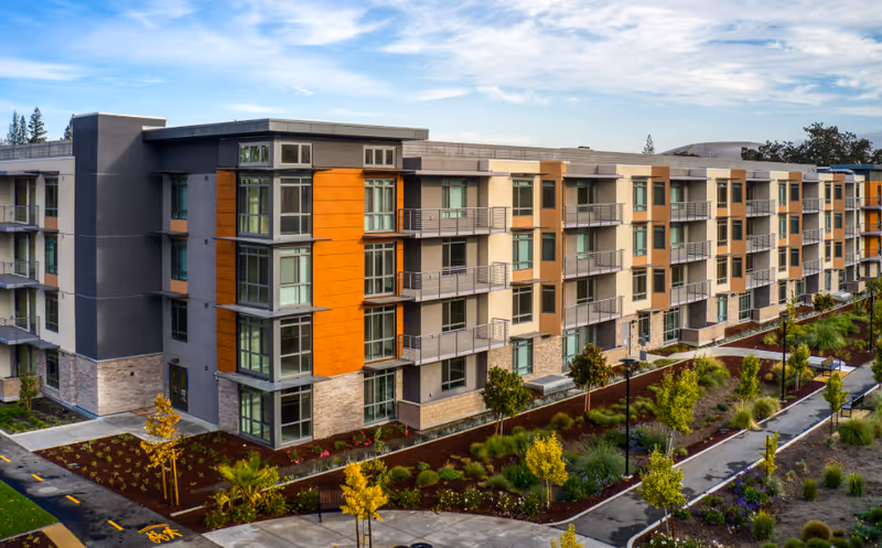Modern, multi-story senior living building exterior with landscaped walkways in Walnut Creek.