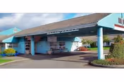 Front view of Heartwood Extended Health Care building with teal exterior and covered entrance.