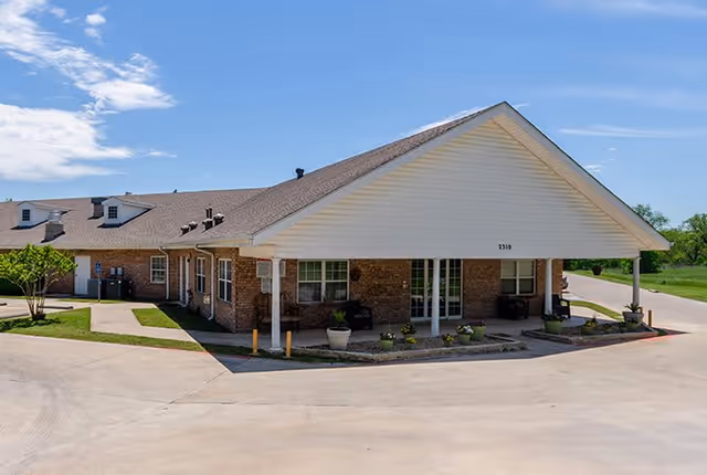 Exterior view of Wheeler Terrace showing the entrance and surrounding landscaping on a sunny day.