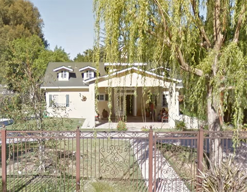 Exterior of Royal Garden Board & Care III with entry porch and iron gate.