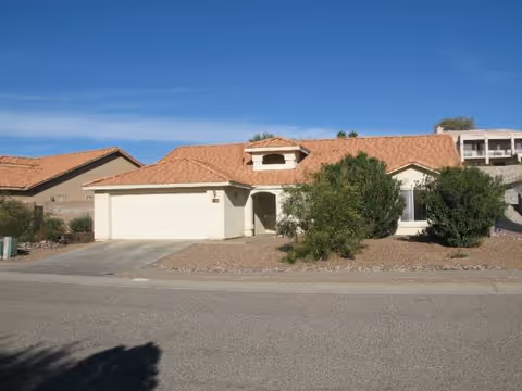 Front exterior of Grace Home II, a single-story facility with desert landscaping and driveway.