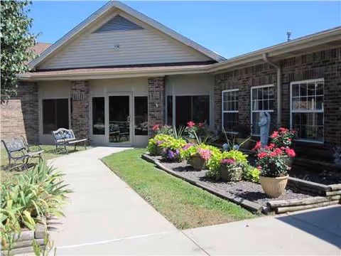 Front entrance of Strafford Care Center with garden and patio seating