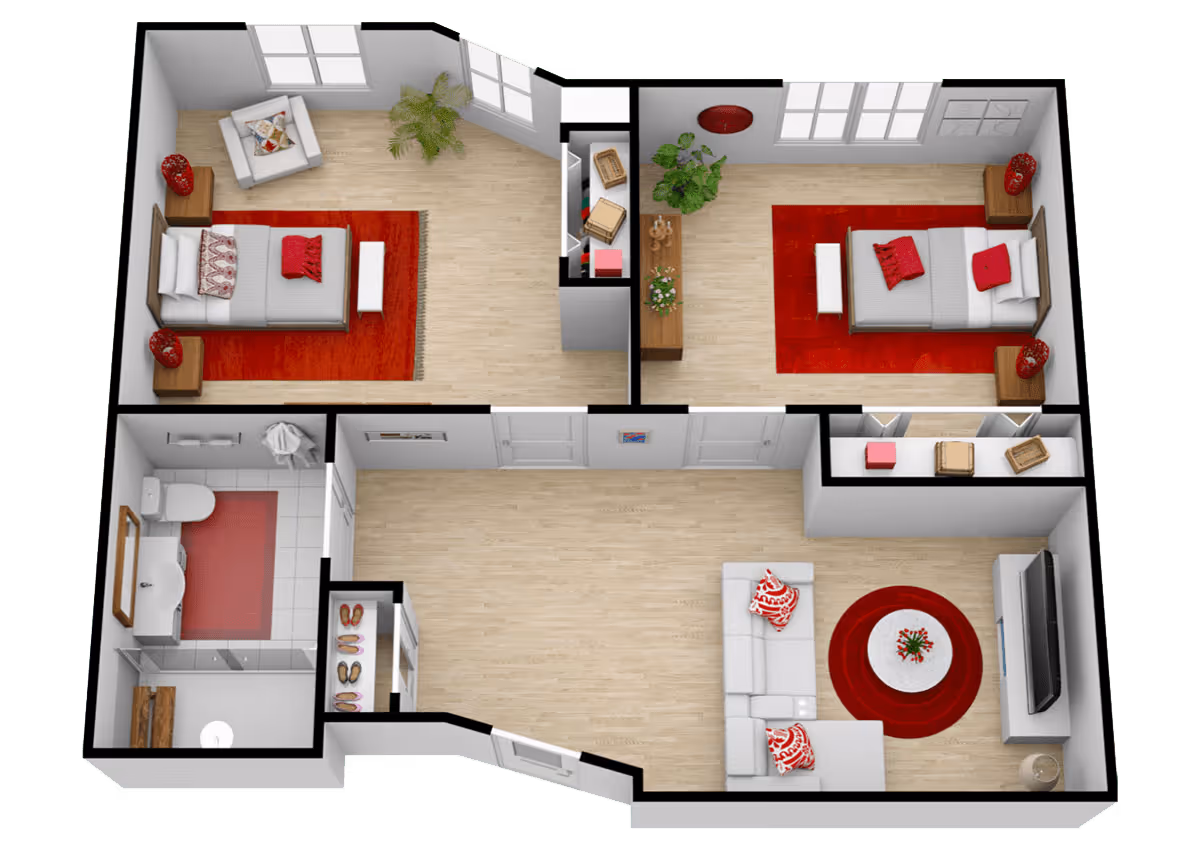 3D floor plan of a senior living apartment at The Havens at Antelope Valley showing two bedrooms with beds, nightstands, and chairs, a bathroom with a toilet and sink, a living room with a sofa, coffee table, and TV, and a hallway with closets and plants. The rooms have light wood flooring and red accents including rugs and pillows.