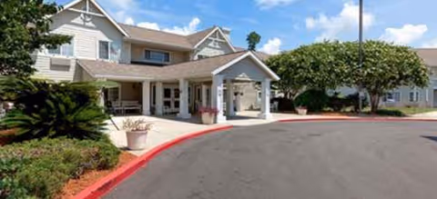 Brookdale Biloxi entrance with a covered drop-off and landscaped front.