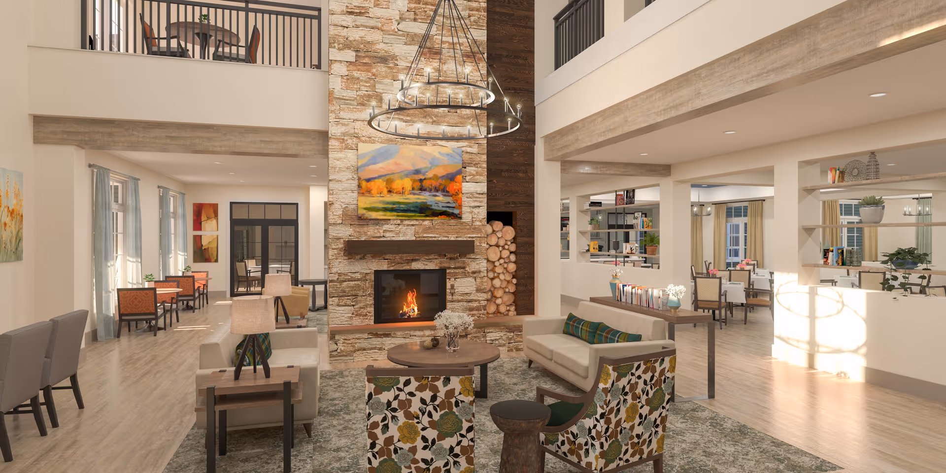 A spacious and well-lit senior living facility common area with a large stone fireplace at the center. The room features comfortable seating including sofas and floral-patterned chairs arranged around a round wooden coffee table. There are bookshelves with books and plants, large windows with curtains, and a chandelier hanging from the high ceiling. In the background, there are dining tables and chairs, and an upper balcony area is visible.