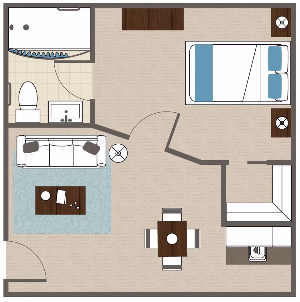 Top-down floor plan of a one-bedroom assisted living apartment showing a bedroom, bathroom, living area, dining table, and kitchenette.