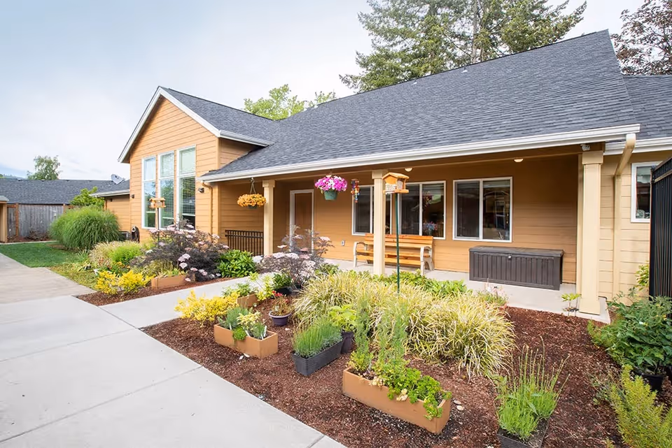 Exterior view of McKenzie Living Springfield featuring landscaped gardens and a covered entrance.