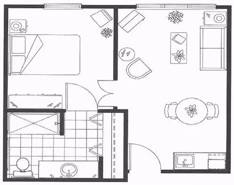Black and white floor plan of a small apartment unit showing a bedroom with a bed and nightstand, a bathroom with a shower, toilet, sink, and a living room area with a sofa, chairs, coffee table, dining table with chairs, and a kitchenette with a sink.