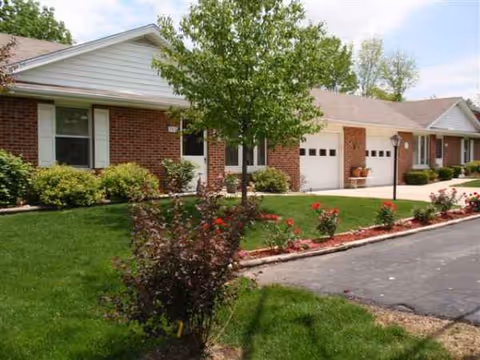 Grace Brethren Village exterior: a single-story brick senior living building with manicured lawn.
