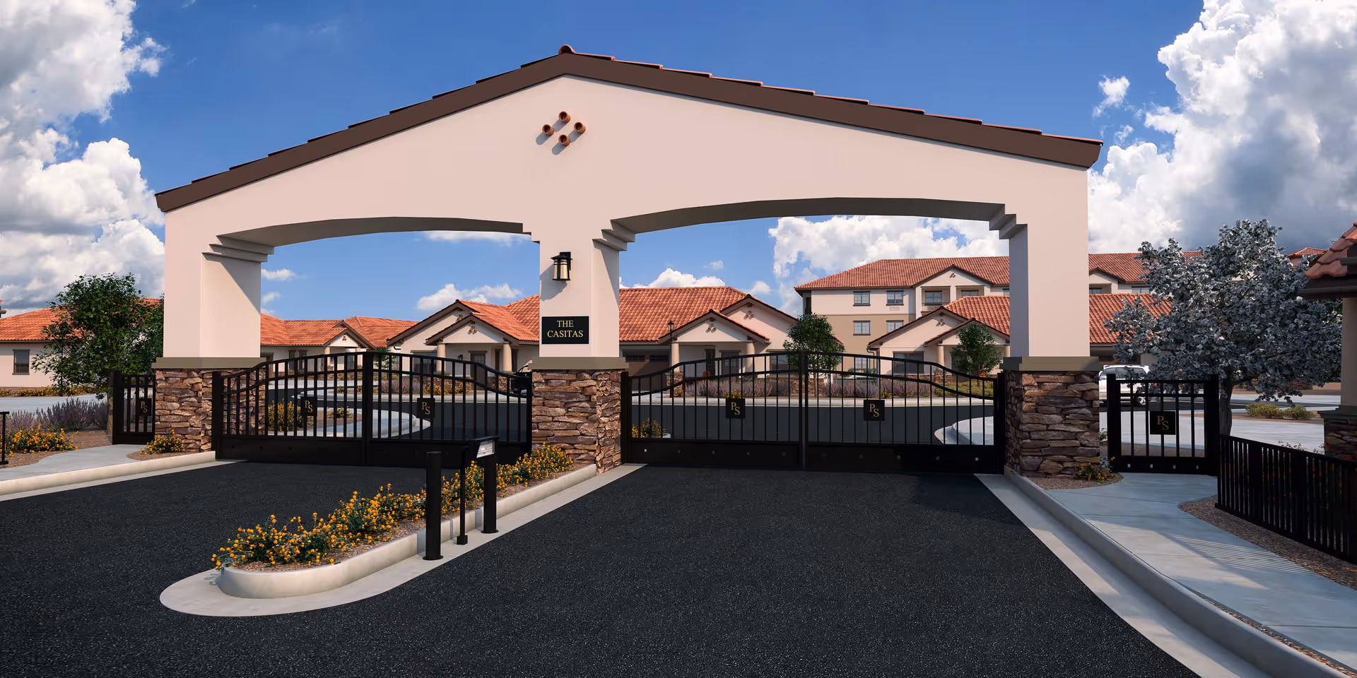 Gated entrance with a stucco archway and wrought-iron gates leading into a Mediterranean-style senior living complex under a blue sky.