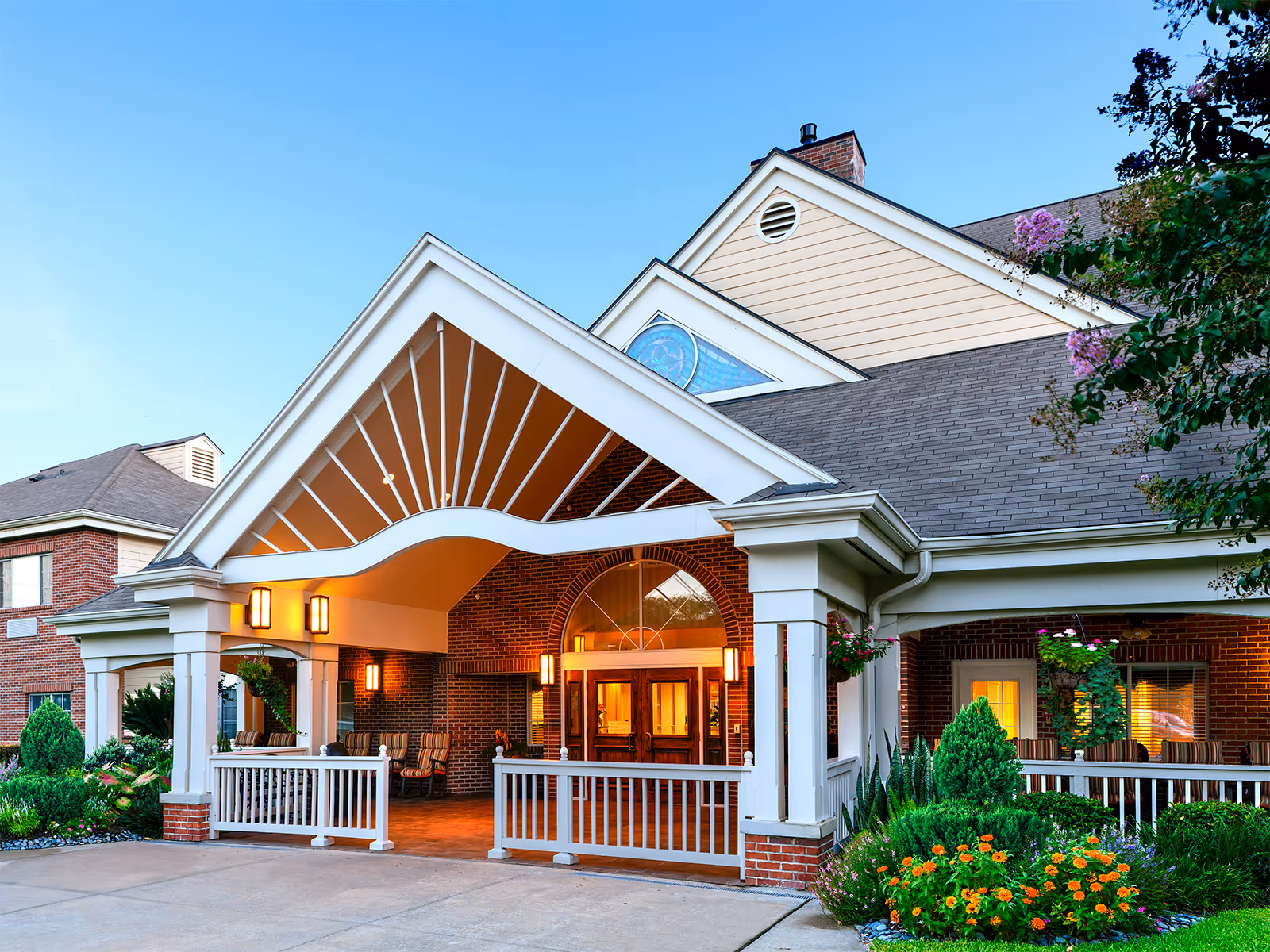 Atria Westchase building entrance with a covered porch and brick facade