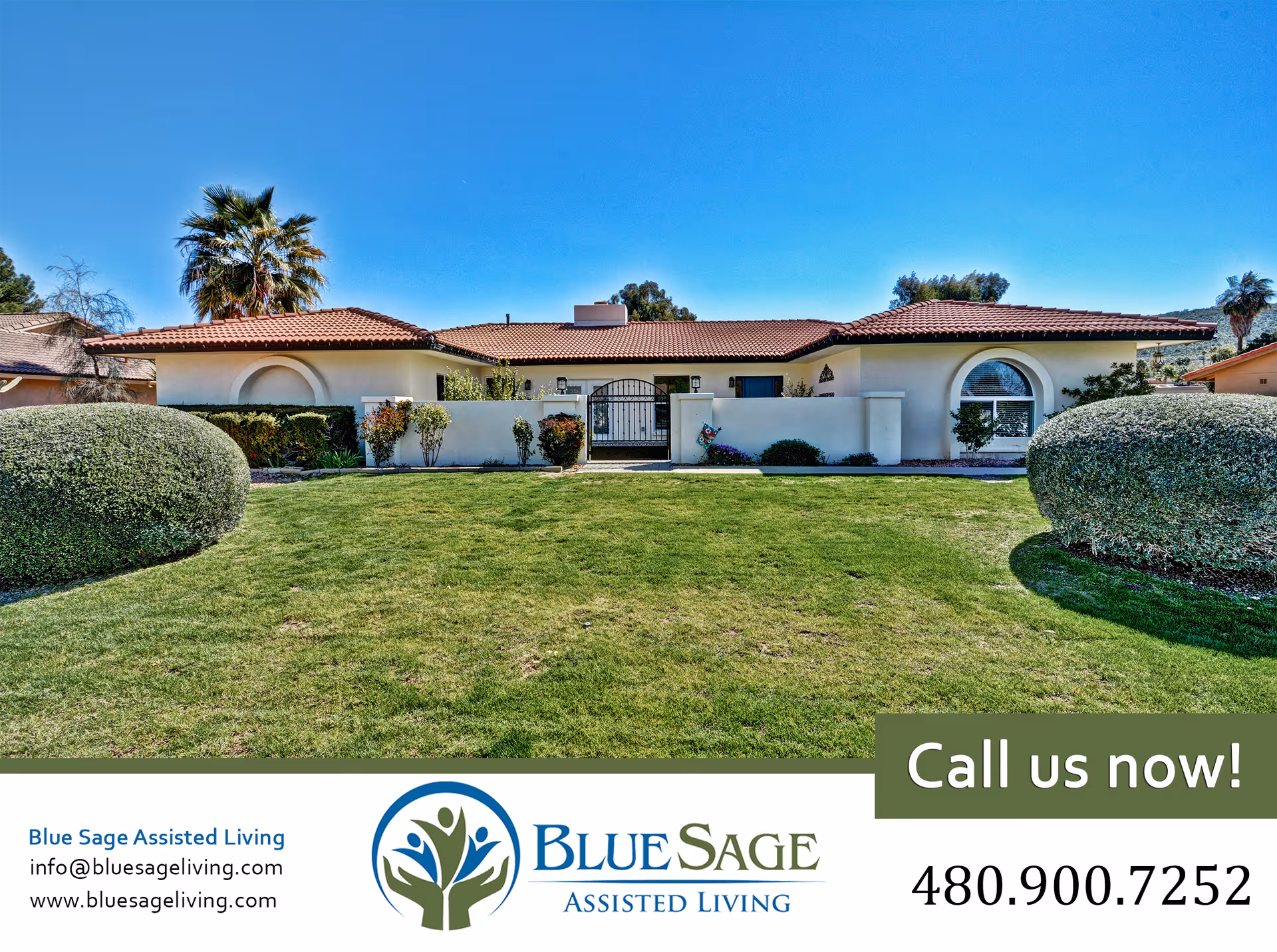 Front exterior view of Blue Sage Assisted Living facility with a well-maintained lawn, trimmed bushes, and a clear blue sky.