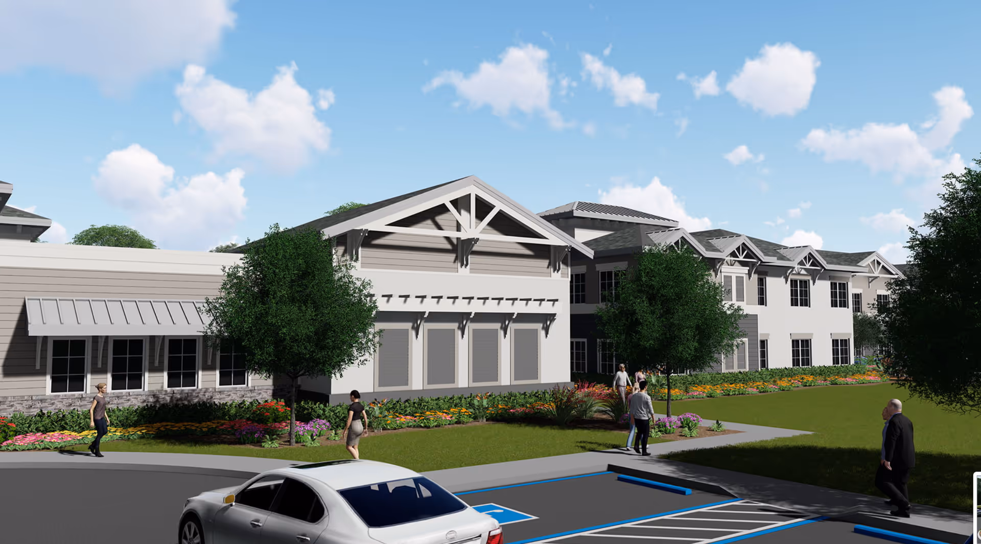 Exterior view of a senior living facility building with a landscaped garden, trees, and a parking area with a silver car. Several people are walking on the sidewalks near the building under a partly cloudy blue sky.