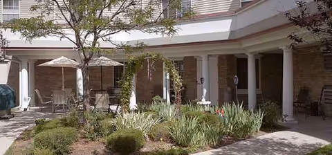 Exterior view of Maria Villa Inc with columns and outdoor seating.