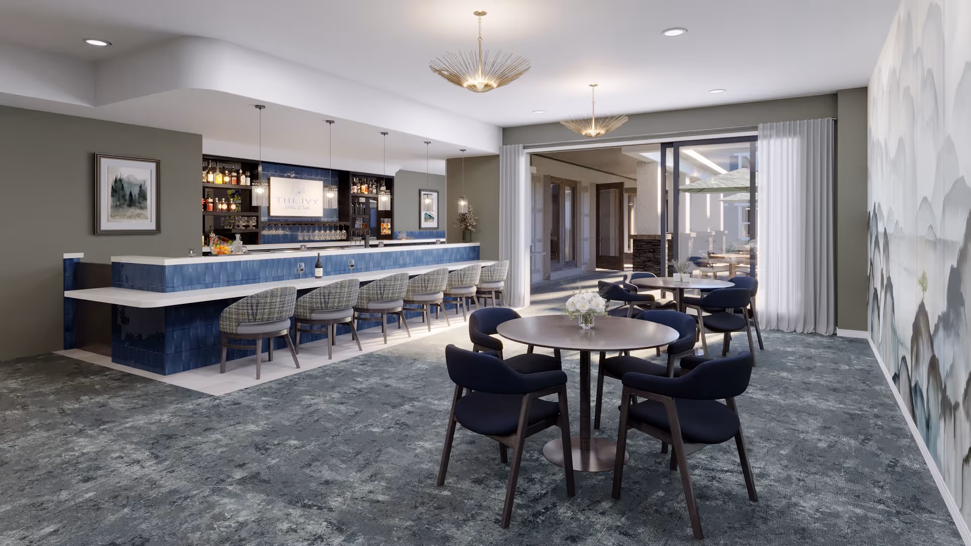A modern lounge area with a blue and white bar featuring several bar stools, round tables with navy blue chairs, decorative lighting fixtures, and a large sliding glass door leading to an outdoor patio with additional seating and umbrellas.
