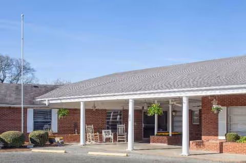 Front entrance of Keller Landing senior living facility with brick walls and white columns.
