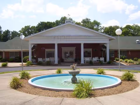 Front entrance of Washington Nursing Center with a circular fountain and landscaped grounds.