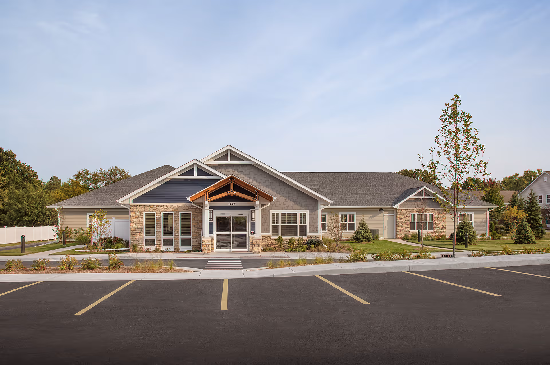 Front exterior of Heritage Woods of McHenry building with parking lot and landscaping.